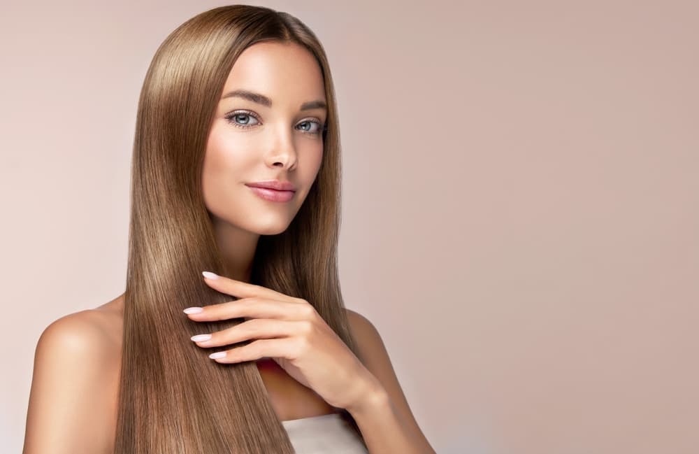 Woman with sleek, smooth hair after keratin smoothing treatment at Honeys Hair & Beauty in Taunton