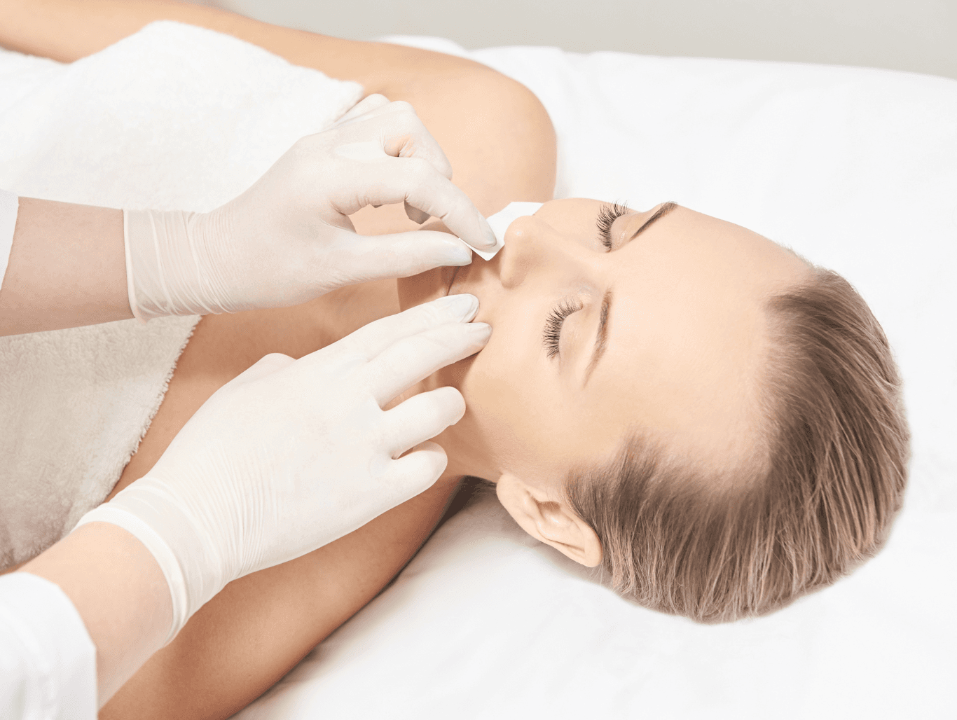 Woman receiving an upper lip and chin wax alongside expert eyebrow shaping at Honeys Hair & Beauty in Taunton for a smooth, polished look.