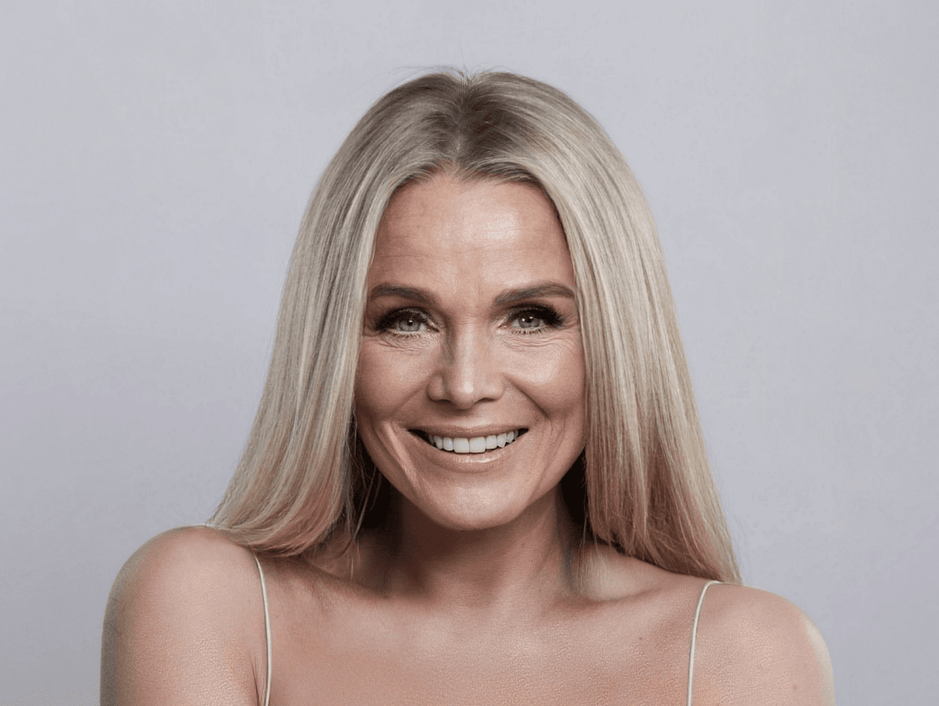 Smiling woman with beautifully bright full head foil highlights, showcasing expert colour work at Honeys Hair & Beauty in Taunton.