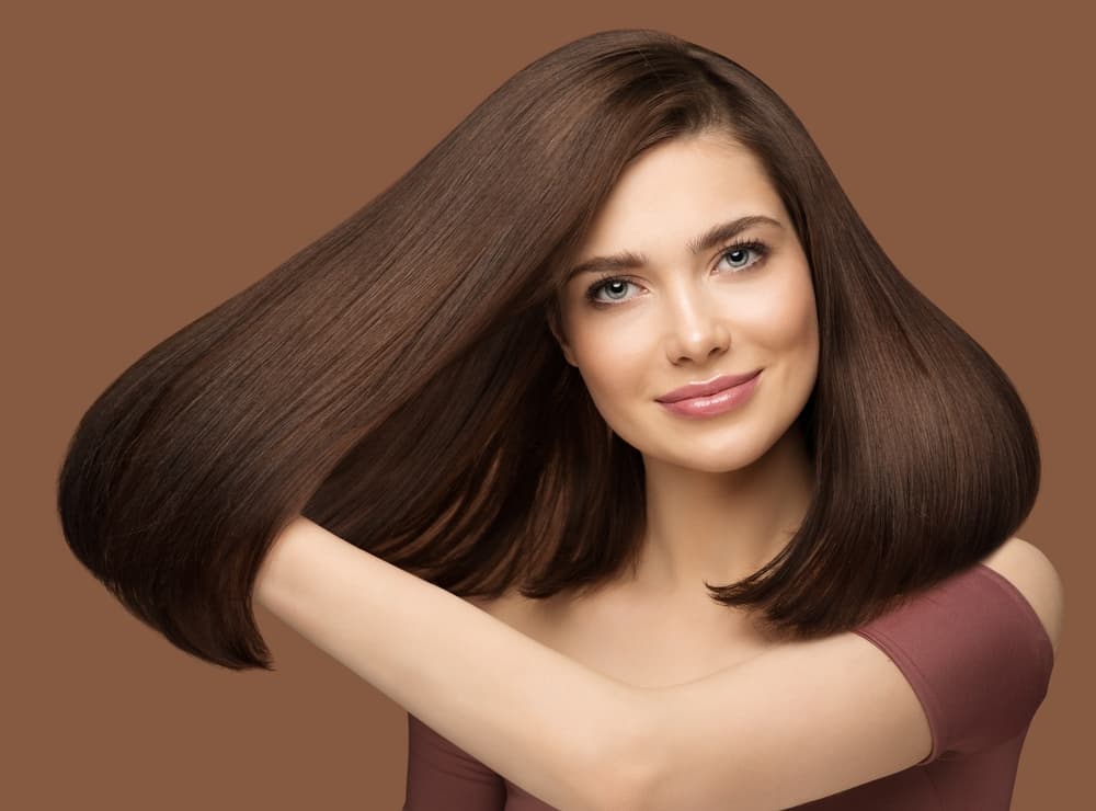 Model with smooth, glossy, frizz-free hair after Keratin Smoothing Treatment (Brazilian Blowdry) at Honeys Hair & Beauty in Taunton