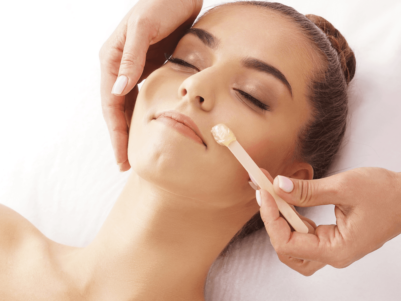 Woman receiving a gentle upper lip and chin wax at Honeys Hair & Beauty in Taunton, leaving the skin smooth, hair-free, and polished.